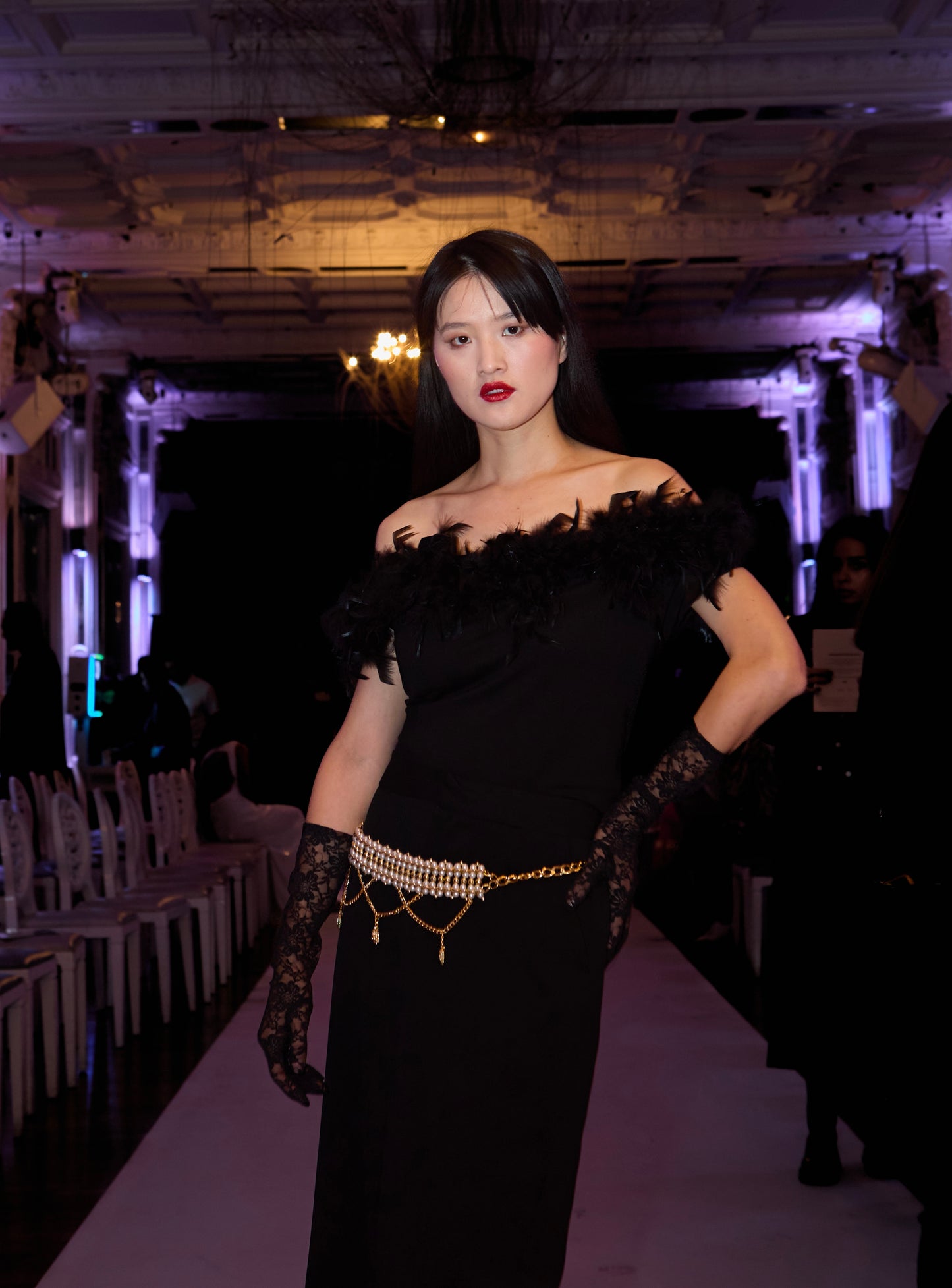 VOLIÀ Atelier - exclusively pre-loved. Each piece is pre-loved and curated with care from around the world, ready to be loved by its new owner. Colette belt from VOLIÀ paired with maxi black skirt, lace gloves and off-shoulder Ines feather top for the perfect party look. Discover curated, high-quality designs for the modern woman. Shop sustainable fashion at VOLIÀ Atelier today.