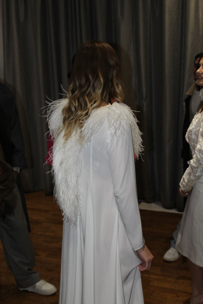 Back view of the white sleek Barbara Dress from VOLIÀ Atelier, highlighting its feather details. VOLIA is exclusively pre-loved