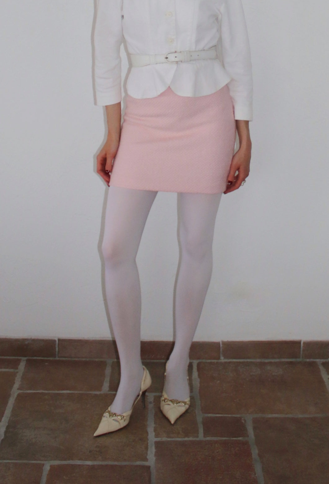 Pink mini skirt paired with white leggings. The Serena Skirt.